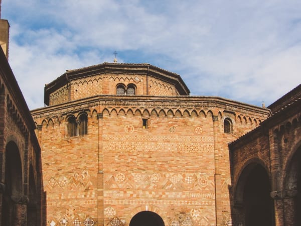 Octagonal brick building with arched windows and detailed carvings.